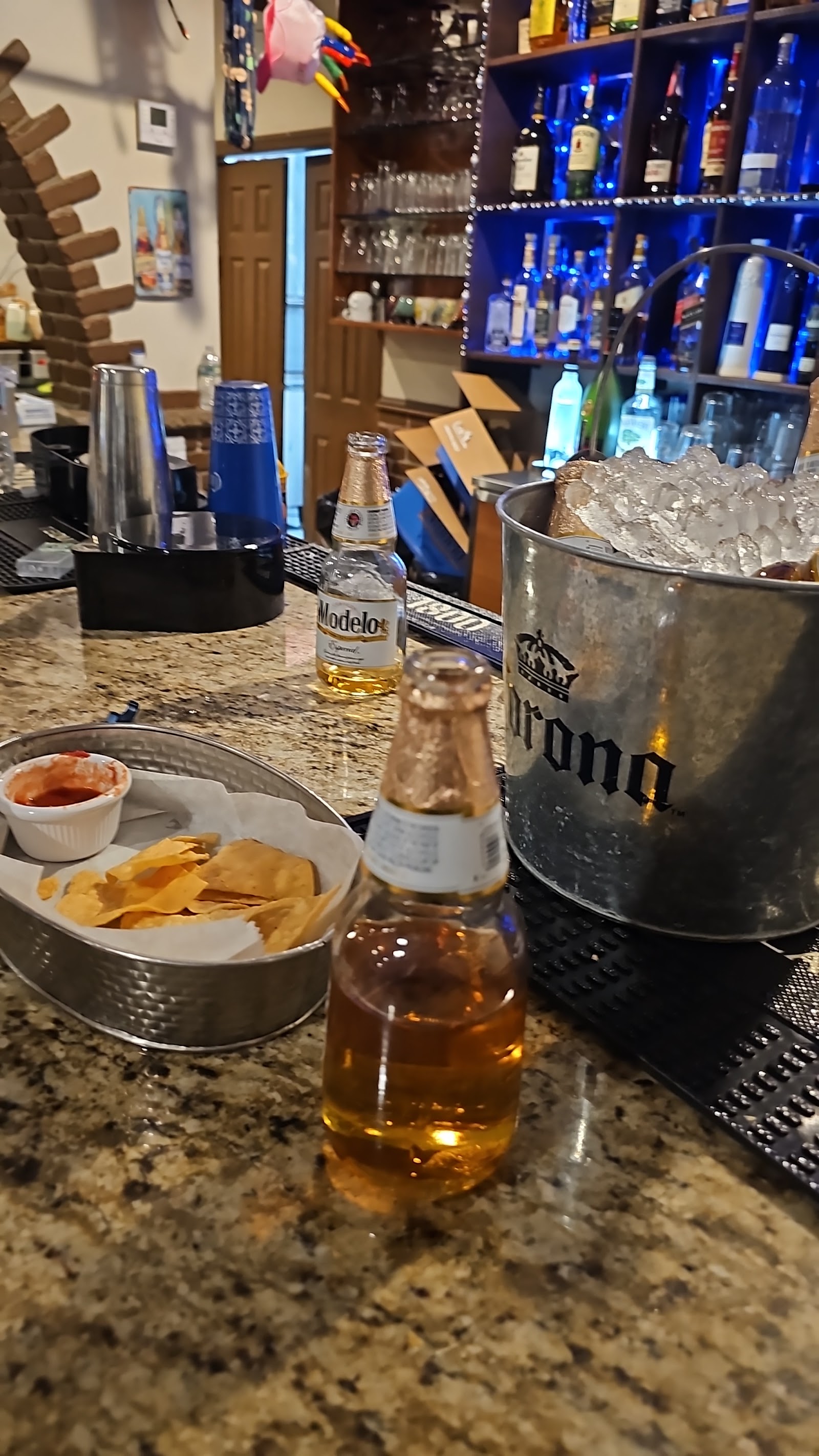 Cathedral bar with cold Modelo, Corona bucket, and fresh chips with salsa