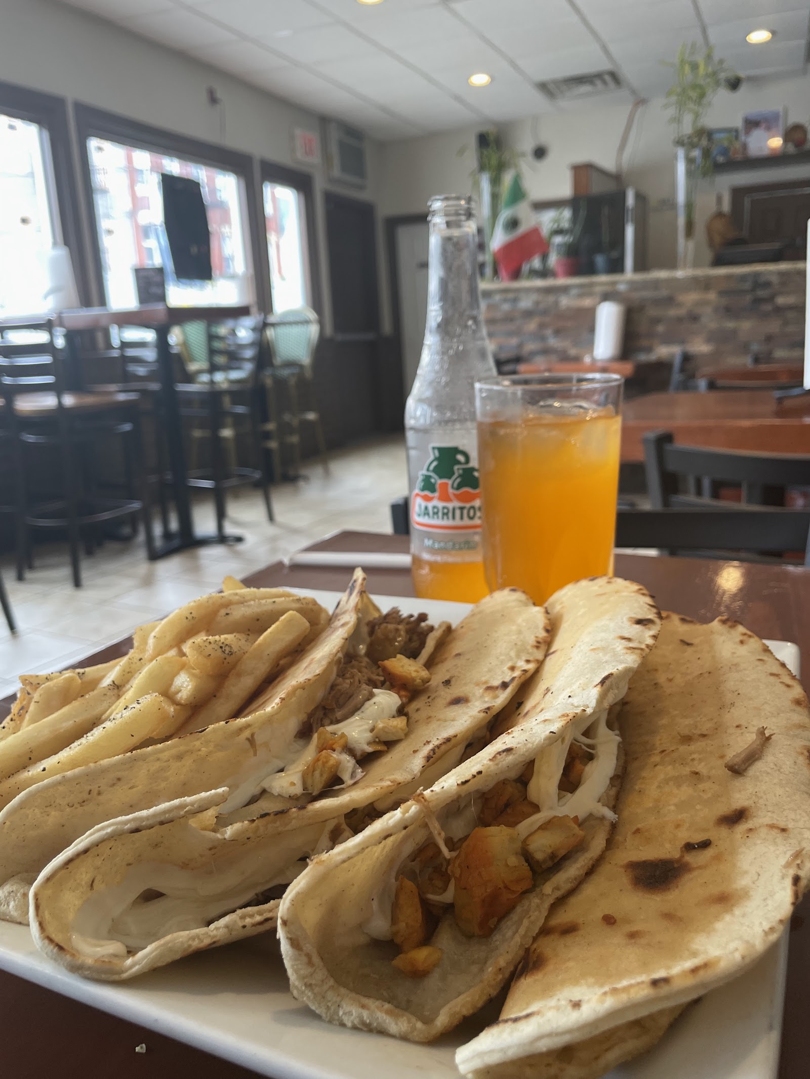 Tacos al pastor with Jarritos on a Cathedral table