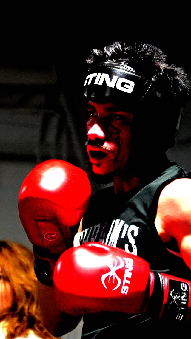 Fighter between rounds with STING headgear and gloves